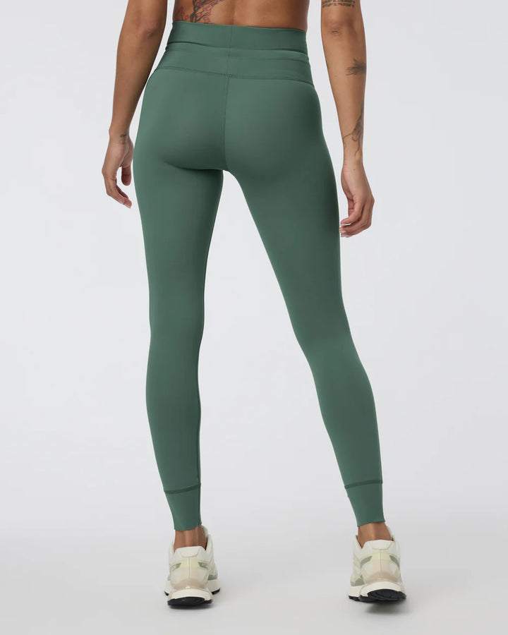Green leggings worn by a person on a white background