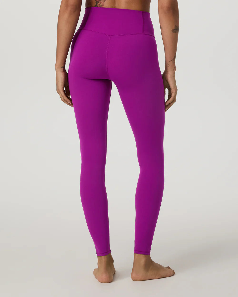 Purple leggings worn by a person on a white background