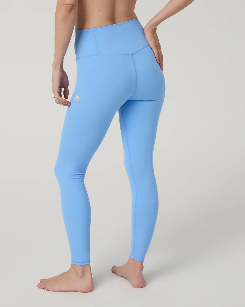 Light blue leggings worn by a person on a plain background