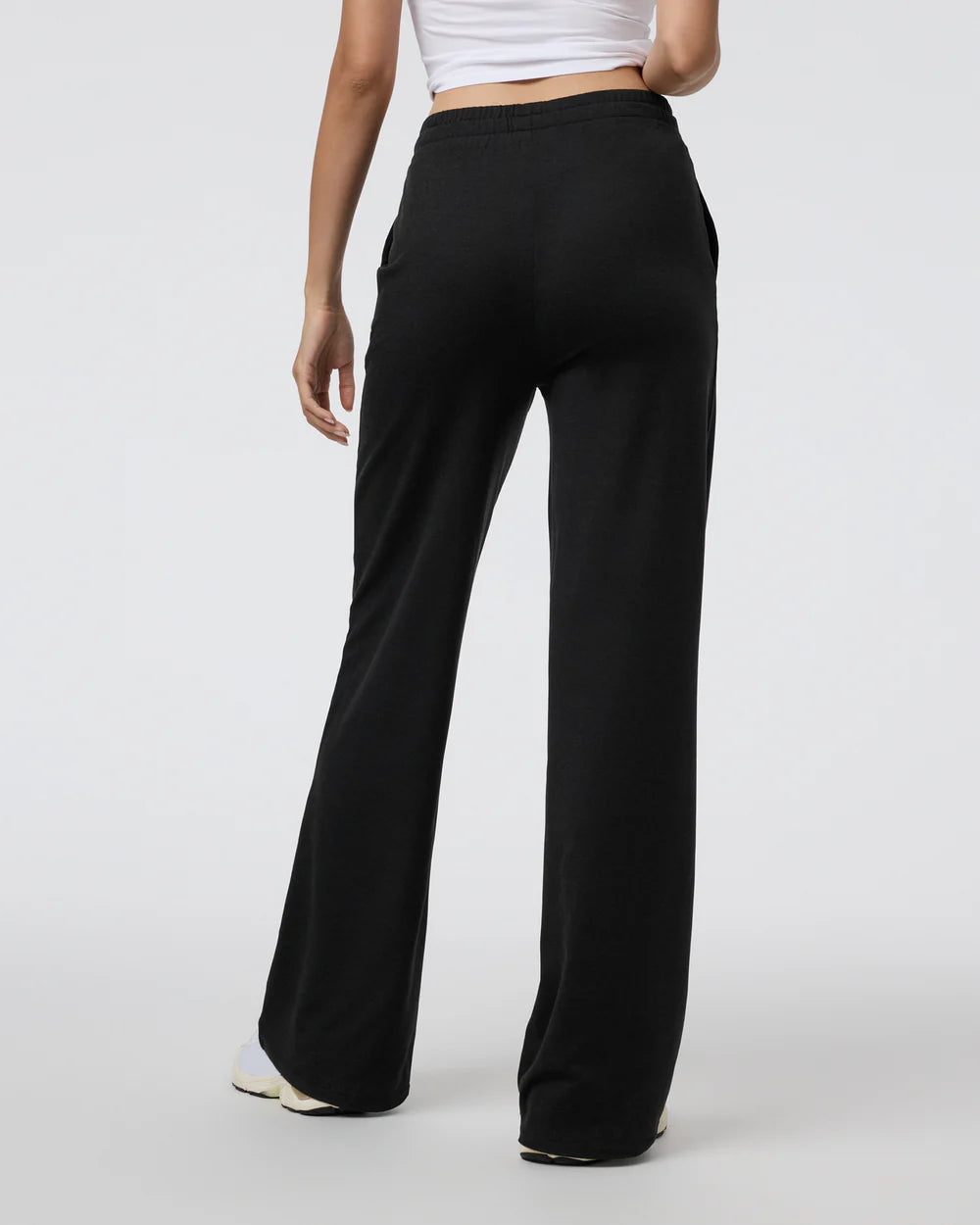 Black wide-leg pants worn by a person on a white background
