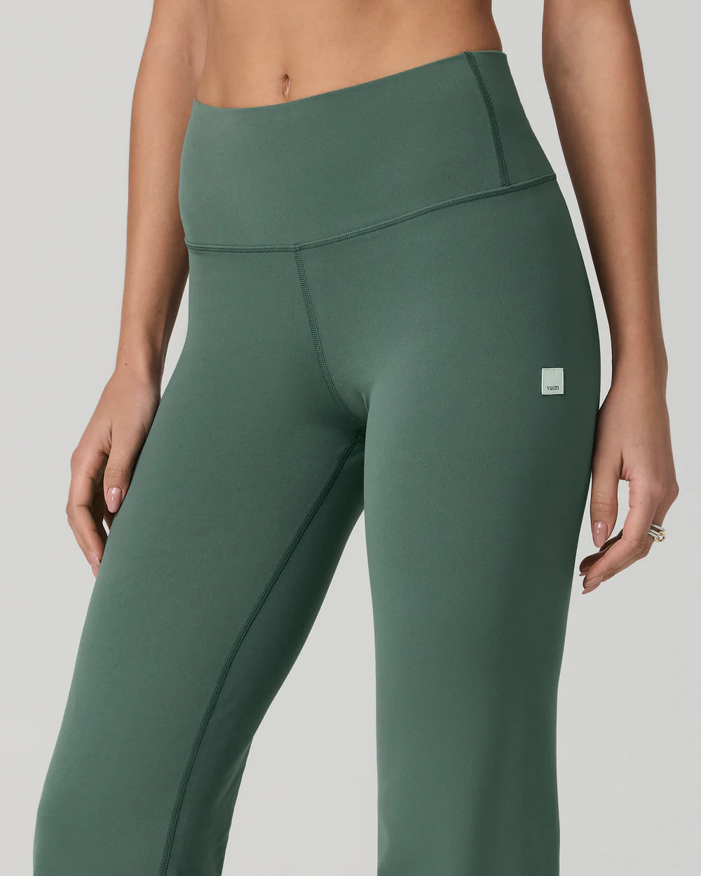 Green leggings with a small logo on a gray background