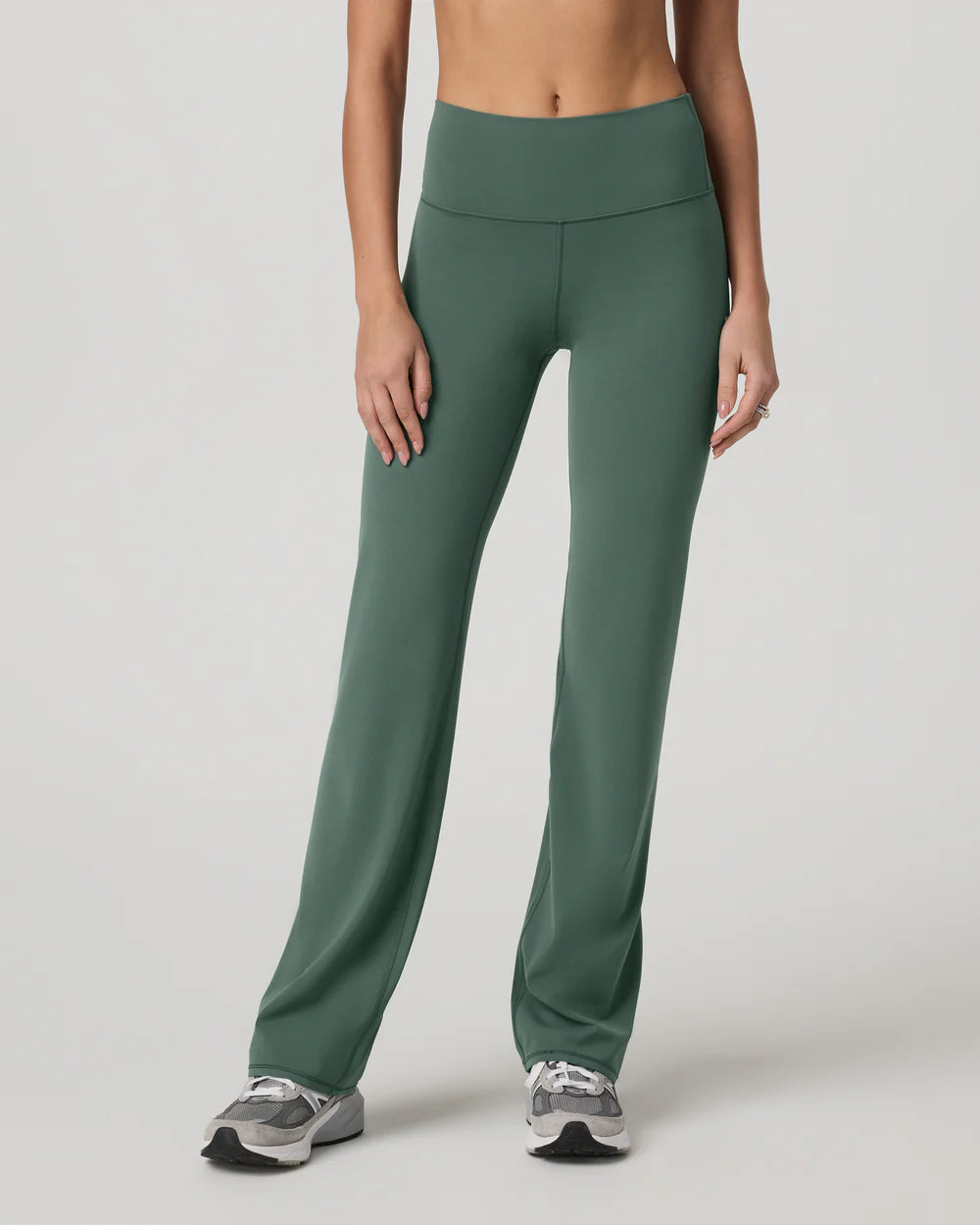 Green leggings worn by a person on a plain background