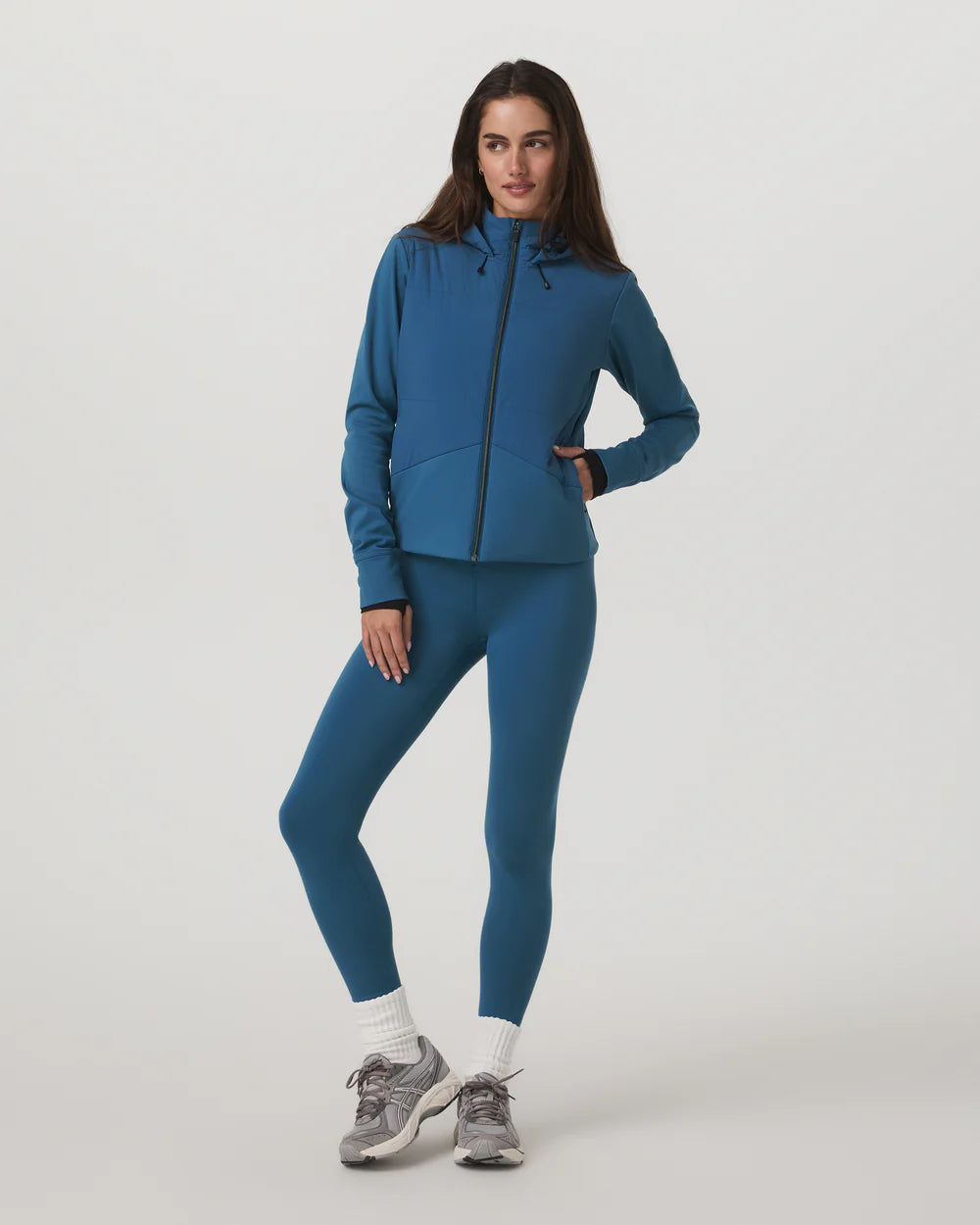 Woman wearing a blue athletic outfit on a white background