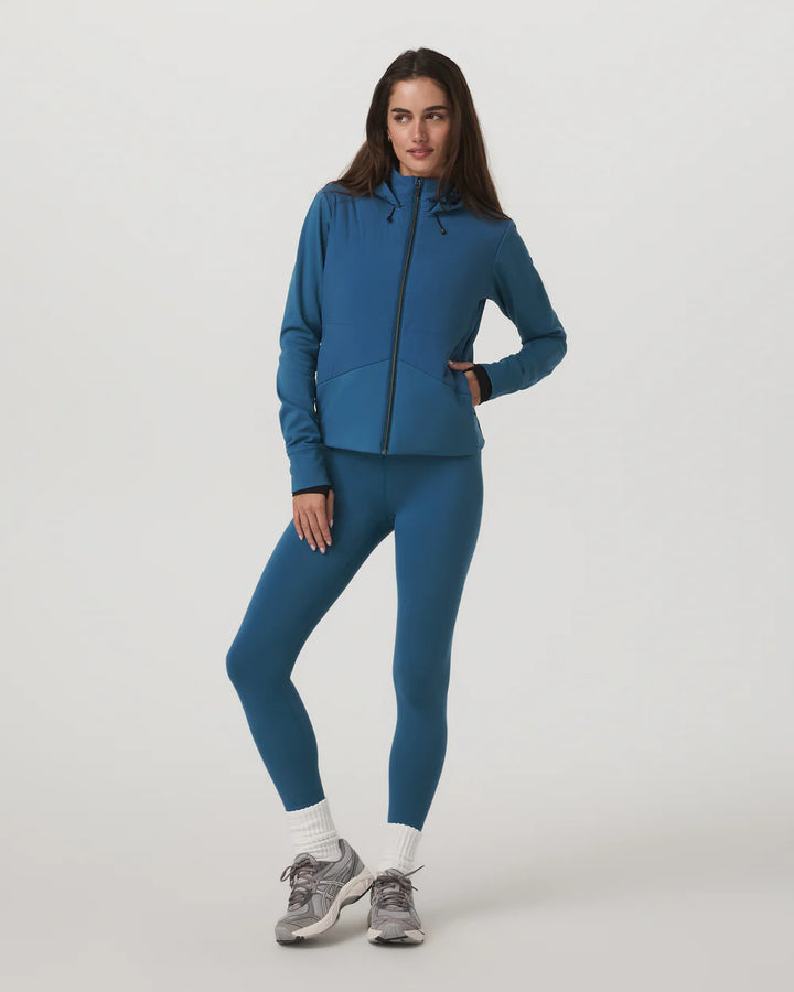 Woman wearing a blue athletic outfit on a white background