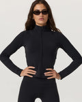 Woman wearing a black outfit with sunglasses on a white background