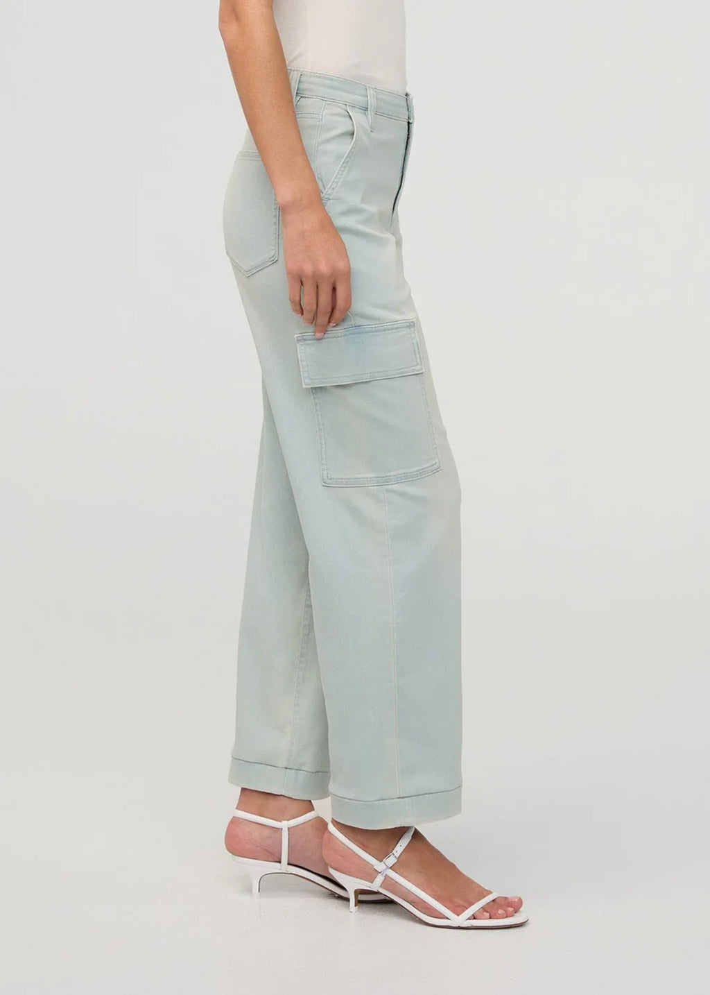 Light blue cargo pants worn by a person on a white background