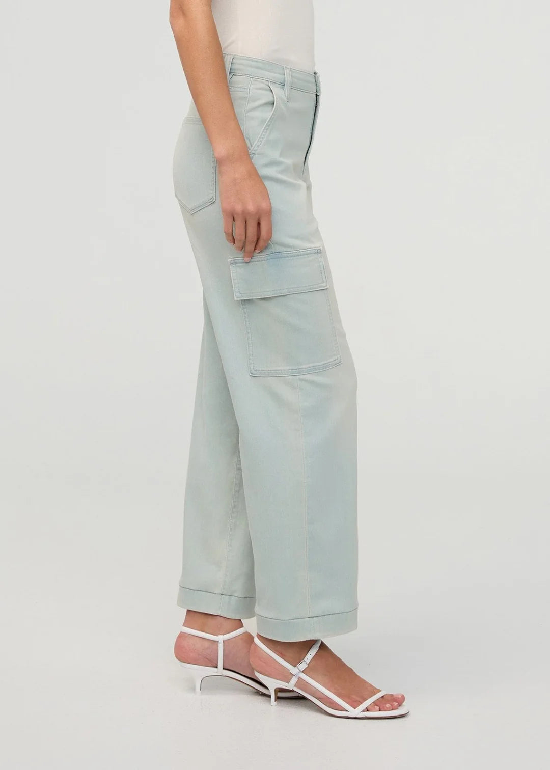 Light blue cargo pants worn by a person on a white background