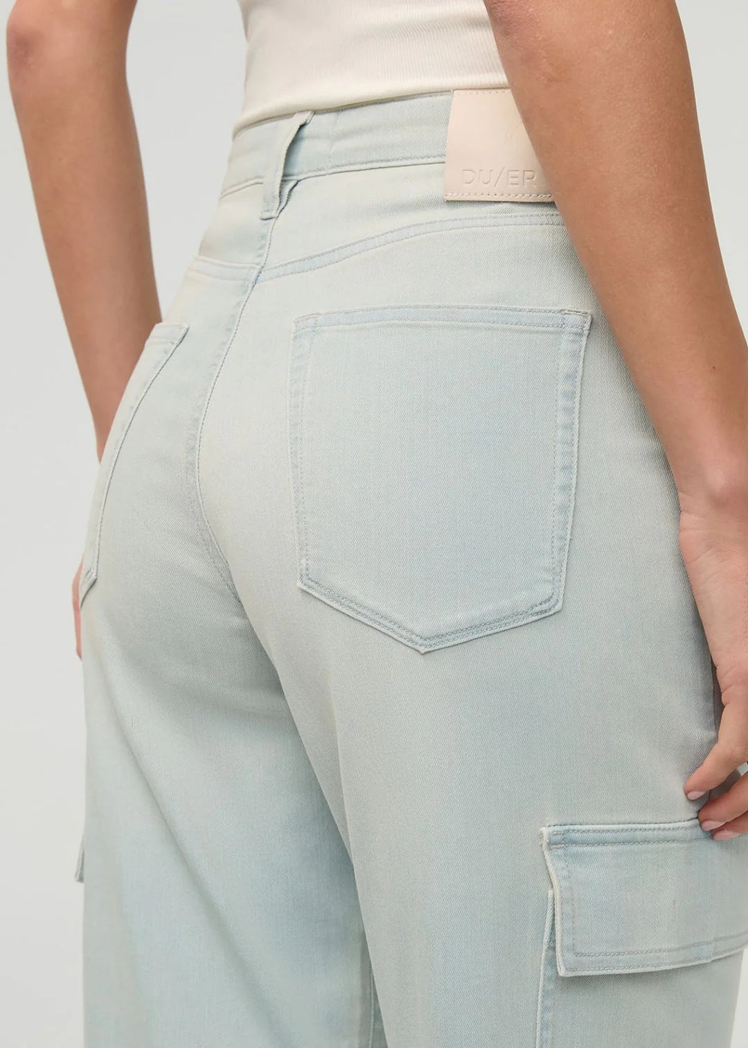 Light blue jeans worn by a person on a plain background