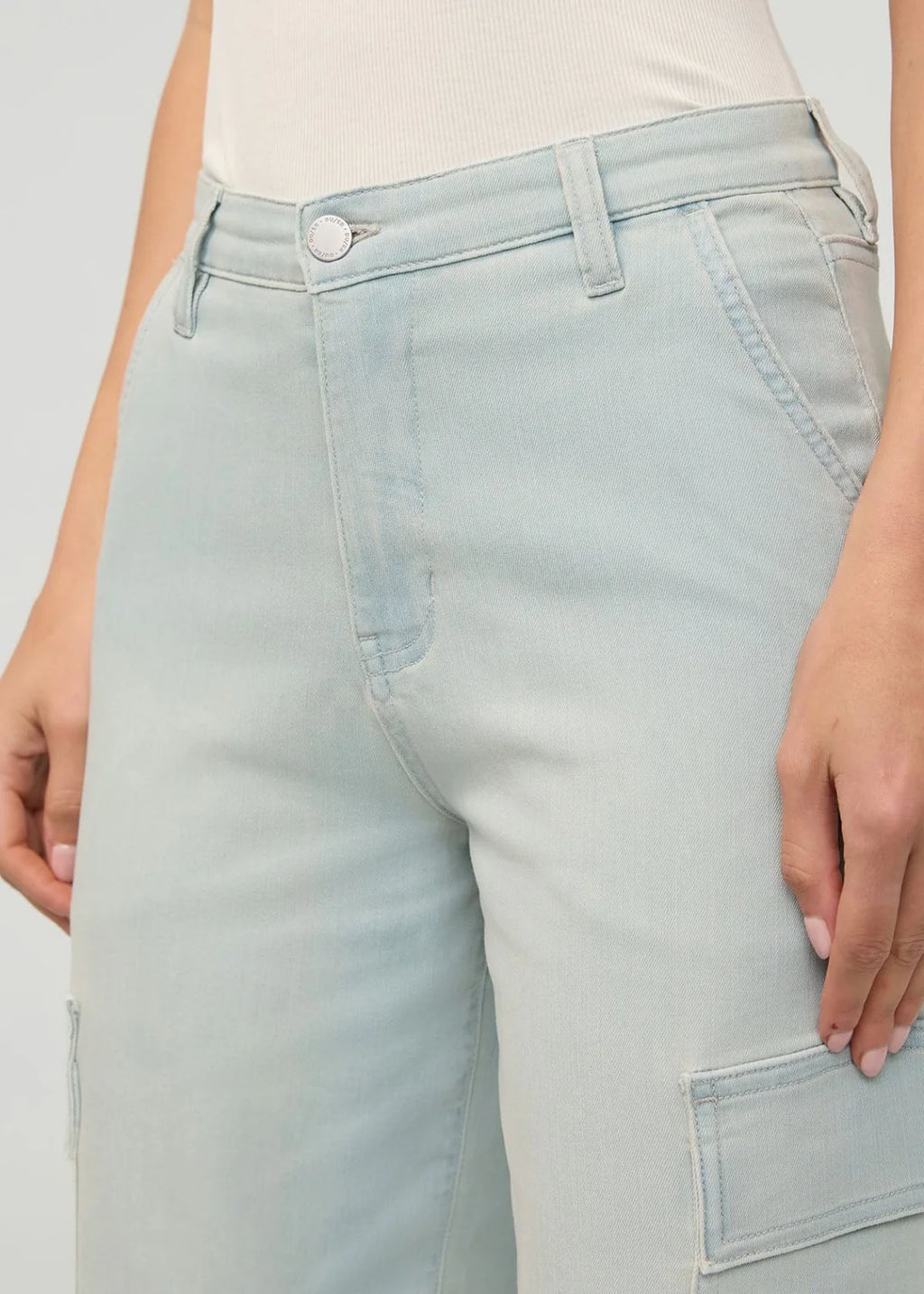Light blue jeans worn by a person on a plain background