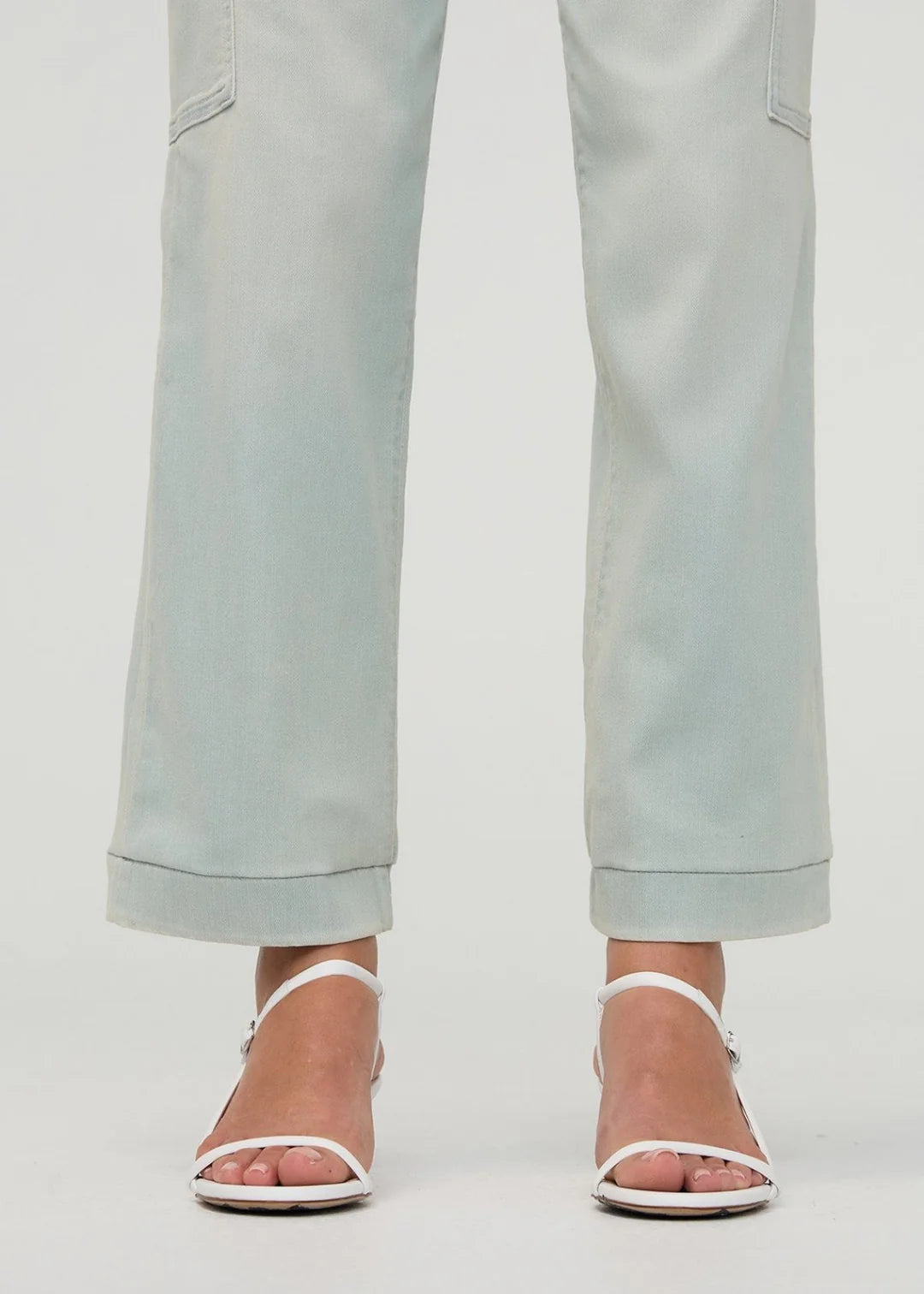 Light blue pants worn by a person on a white background