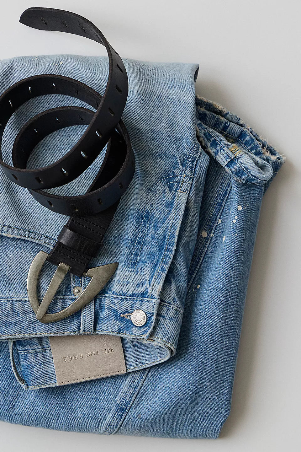 We The Free Noa Belt in black laying on a pair of jeans