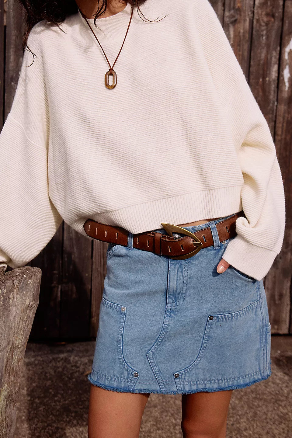 We The Free Noa Belt in cognac on a model wearing a jean skirt and white sweater