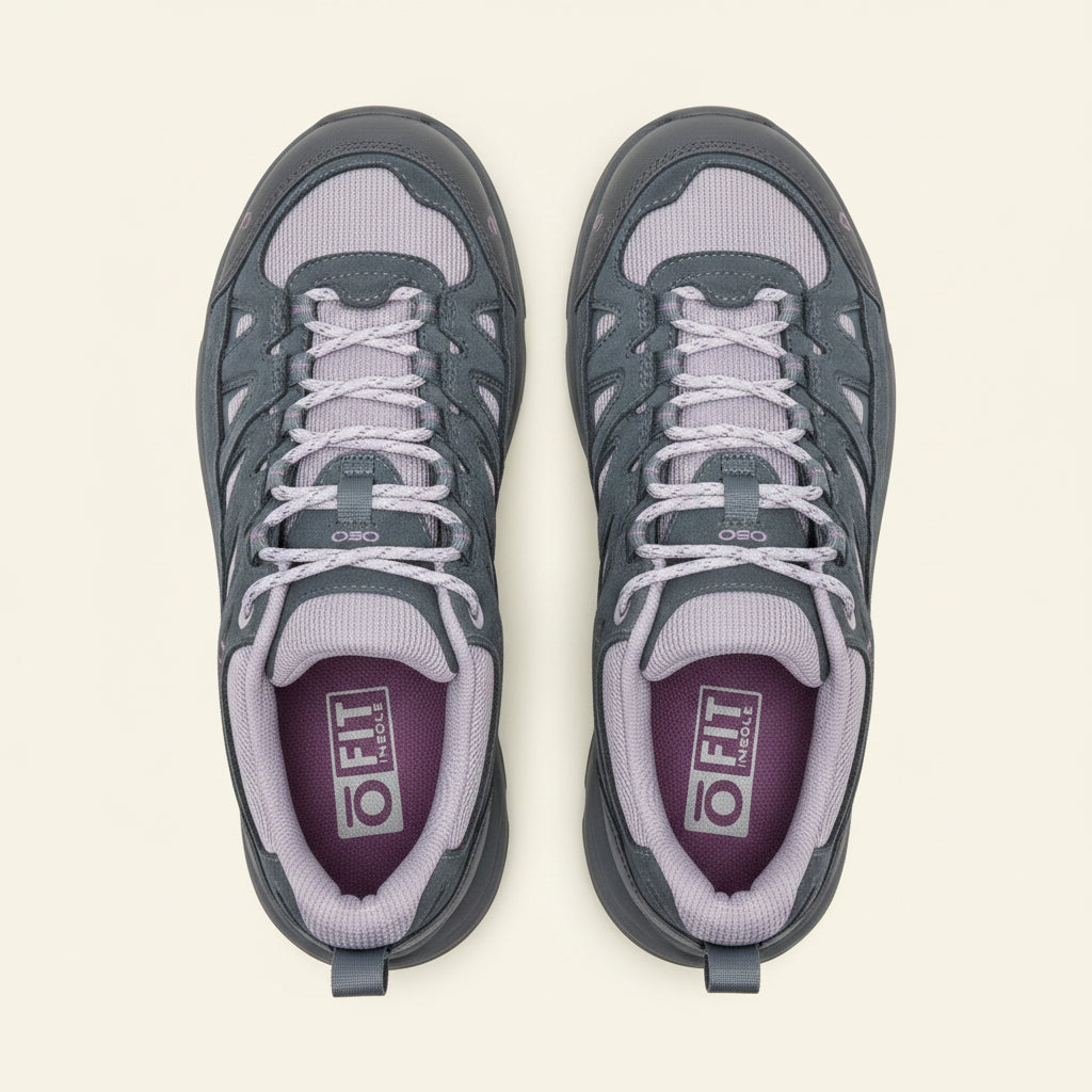 Gray athletic shoe with white laces on a white background