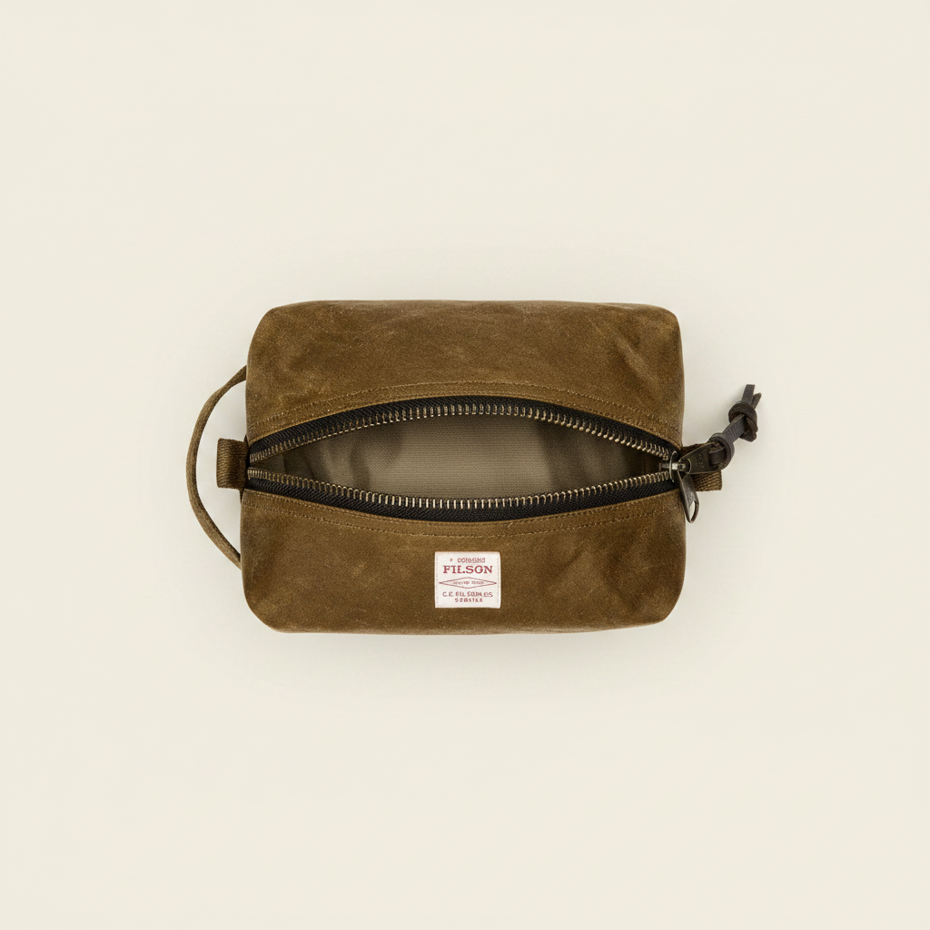 Brown waxed canvas pouch with a zipper on a white background