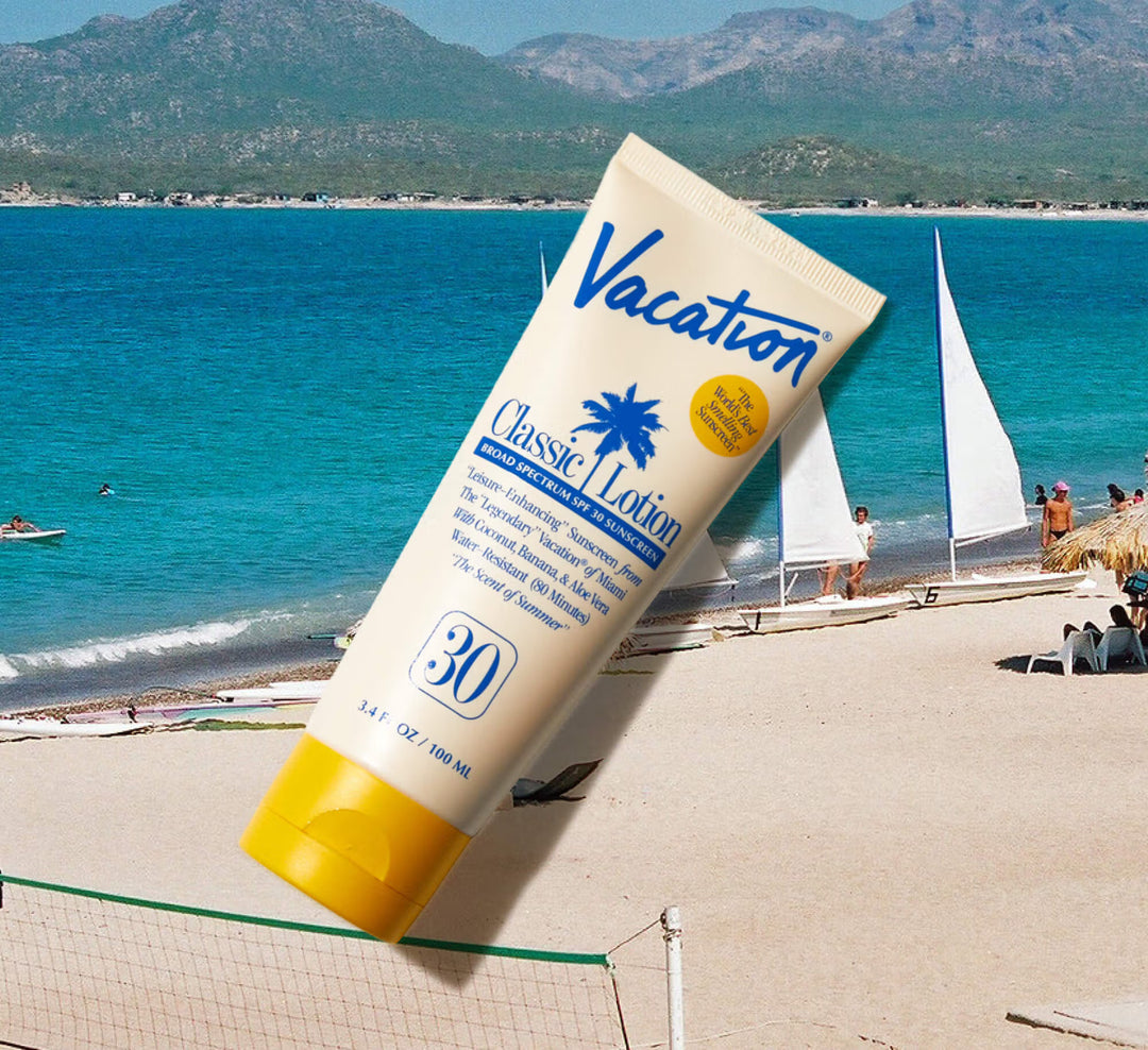 Sunscreen lotion tube labeled 'Vacation Classic Lotion' with beach scene in the background