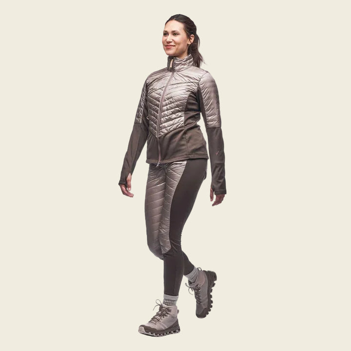 Woman wearing a brown puffer jacket and pants on a white background