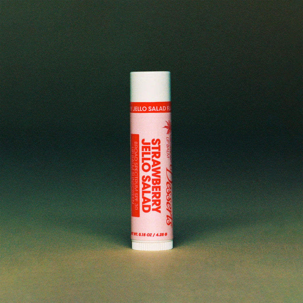 Strawberry Jello Salad Lip Balm on a green background