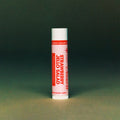 Strawberry Jello Salad Lip Balm on a green background