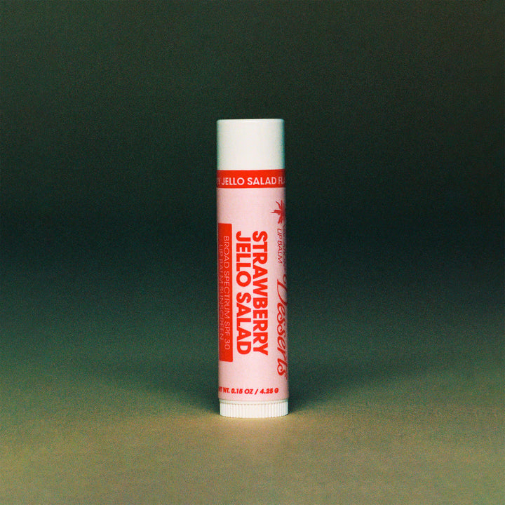 Strawberry Jello Salad Lip Balm on a green background