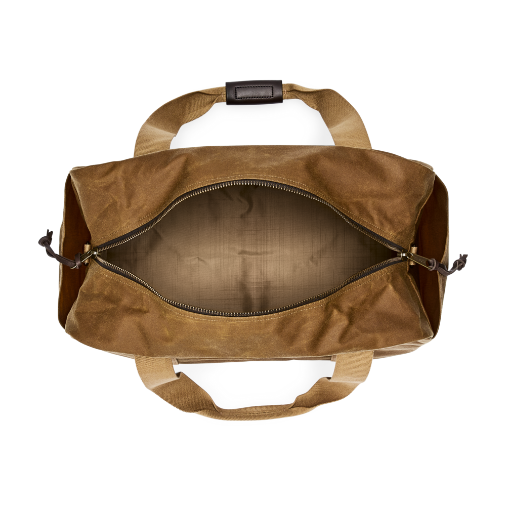 Top-down view of an open brown waxed canvas duffel bag with tan handles and a dark zipper, set against a solid white background.