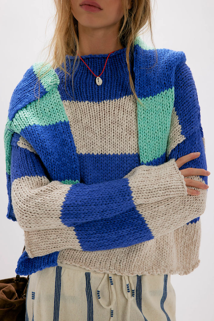 Person wearing a colorful knit sweater with geometric pattern