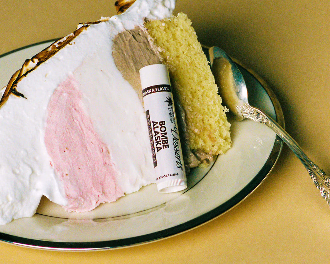Bougie Alaska lip balm on a plate with cake and a spoon