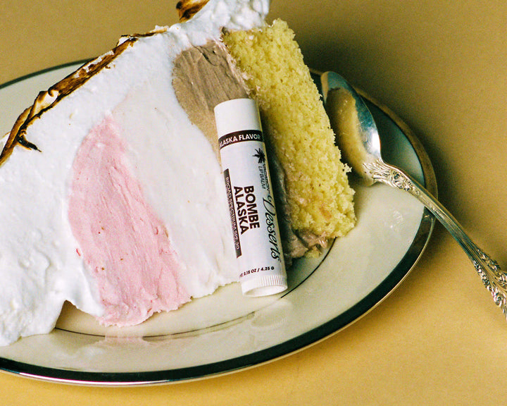 Bougie Alaska lip balm on a plate with cake and a spoon