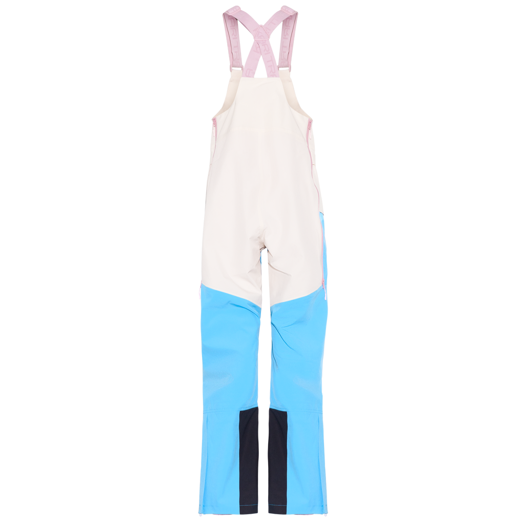 Color-blocked bib overalls with a cream upper body, light blue lower legs, and pink adjustable shoulder straps, shown flat against a white background.