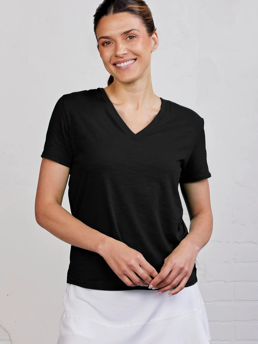 Woman wearing a black V-neck t-shirt against a white background