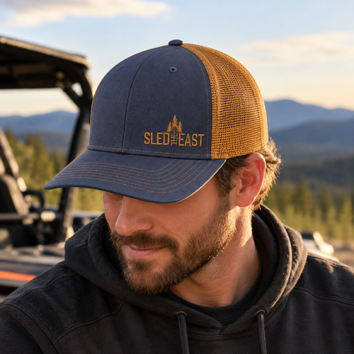 Sled The East Throttle Curved Brim Trucker Hat in Navy/Gold