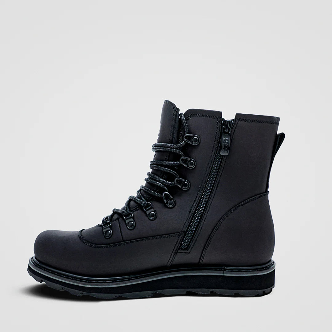 Black boot with zipper on a light gray background