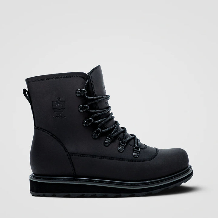 Black boot with laces on a light gray background