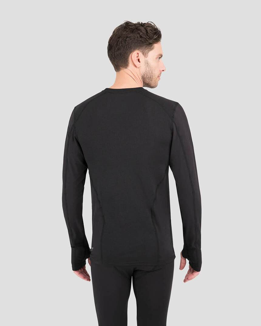 Man wearing a black long-sleeve shirt and pants on a gray background