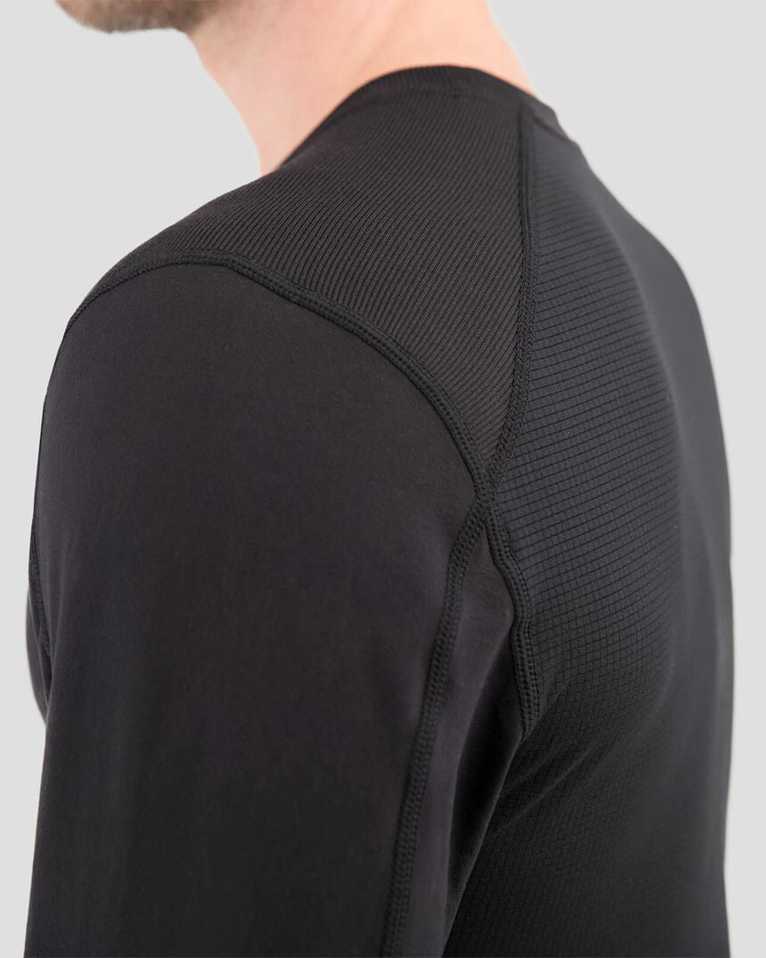 Black long-sleeve athletic shirt with textured shoulder design on a light gray background