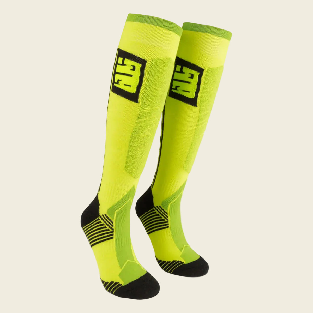Pair of bright yellow knee-high socks with black accents on a white background