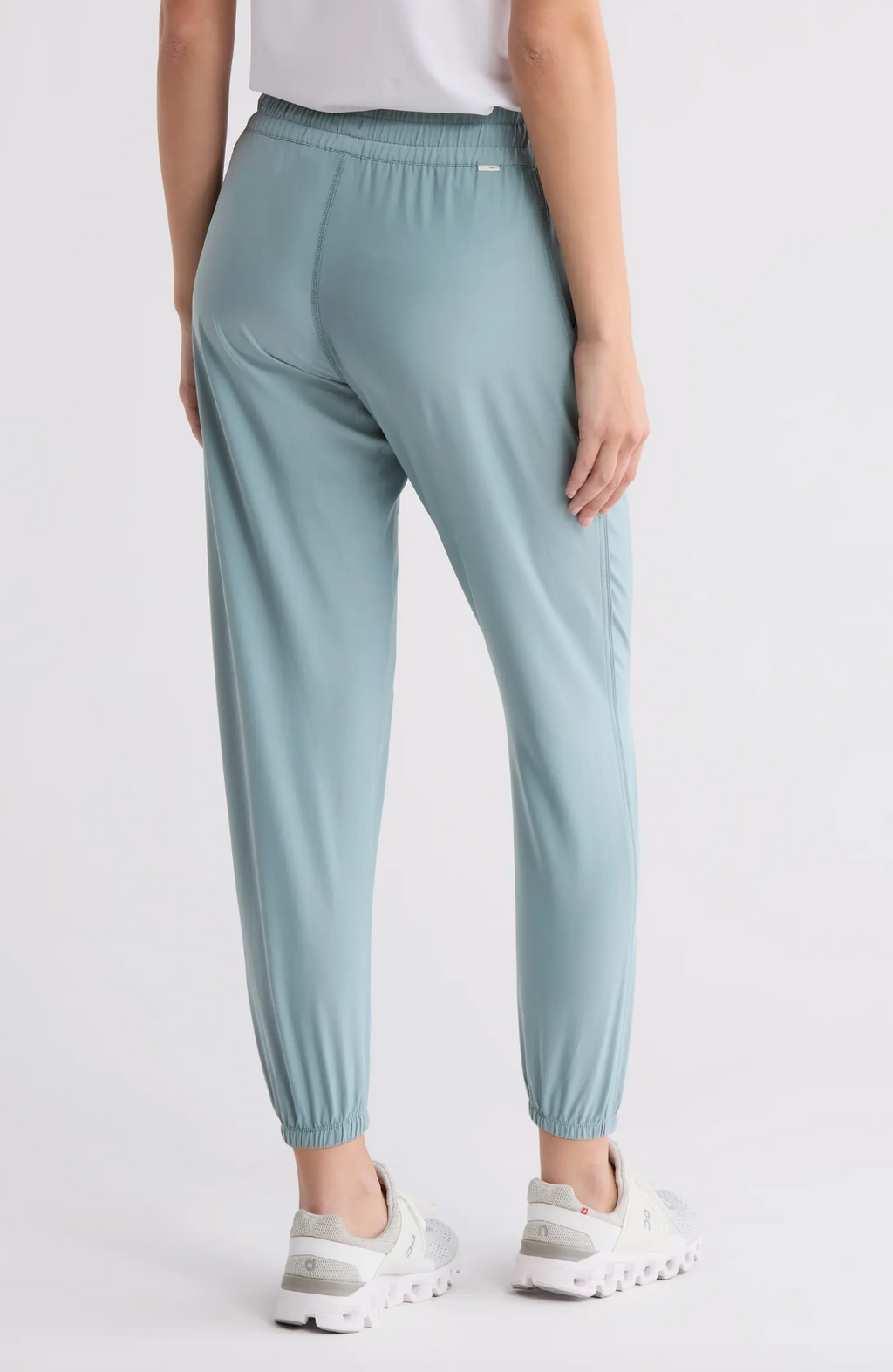 Light blue pants worn by a person on a white background