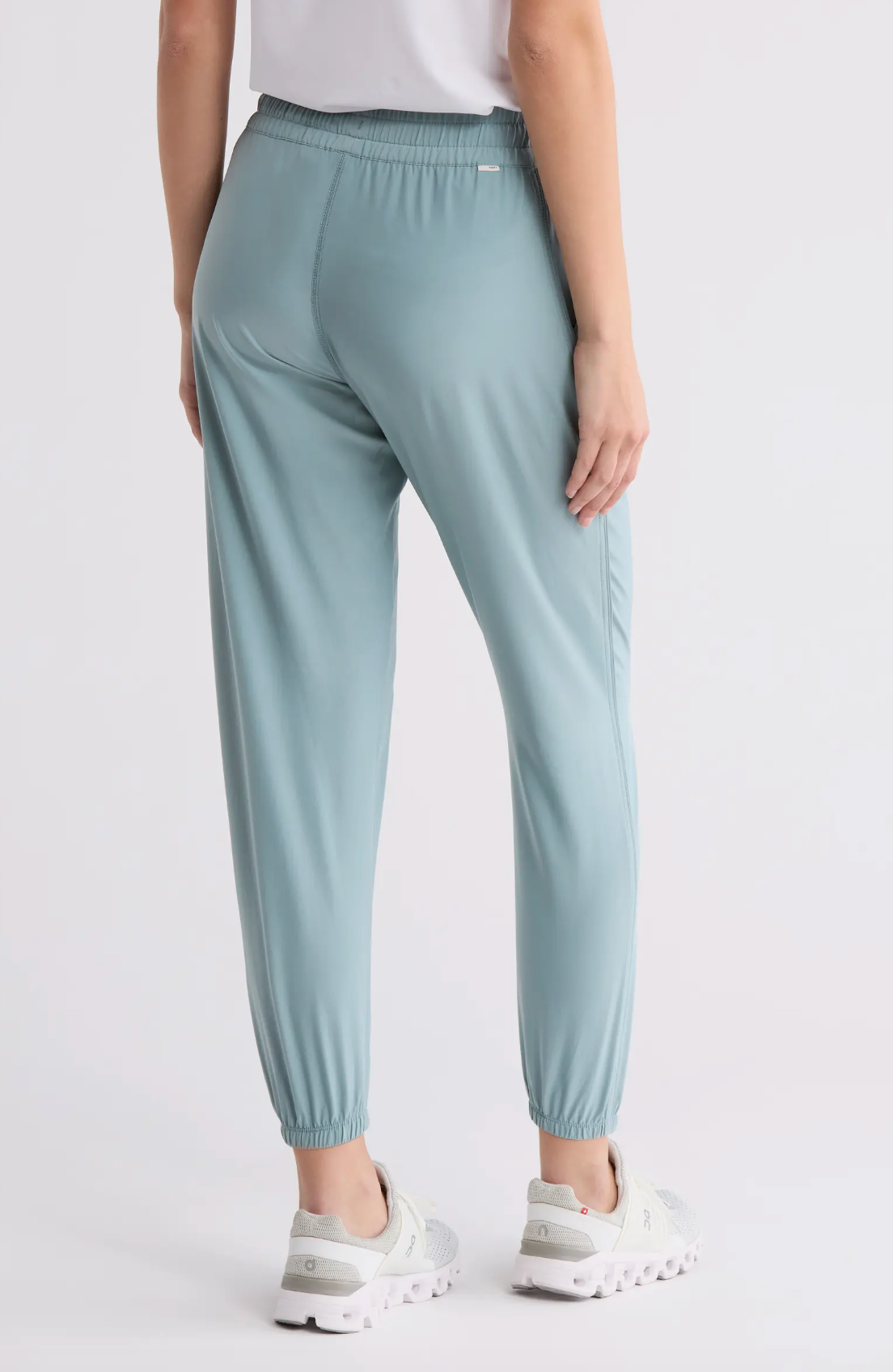 Light blue pants worn by a person on a white background