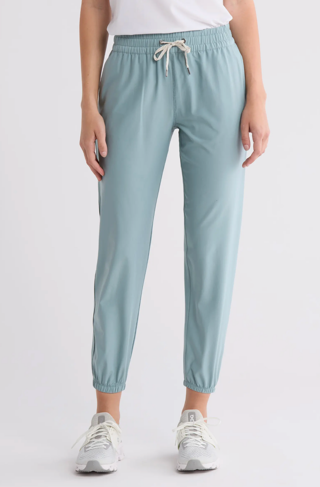 Light blue jogger pants worn by a person on a white background