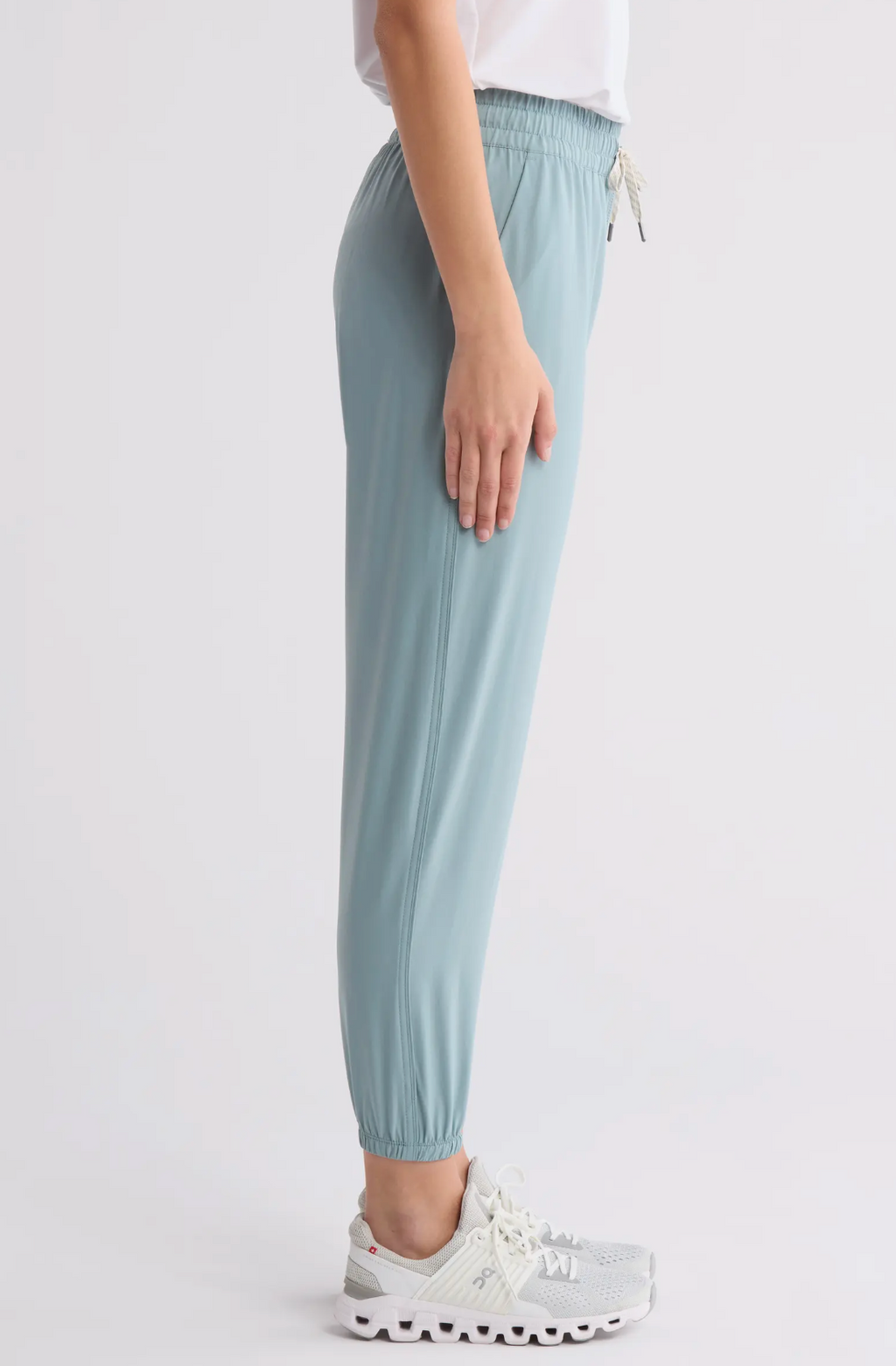 Light blue pants worn by a person on a white background